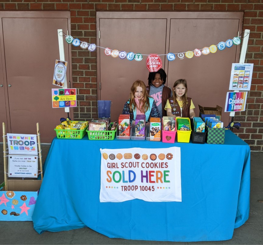 Girl scouts at their decorated cookie booth