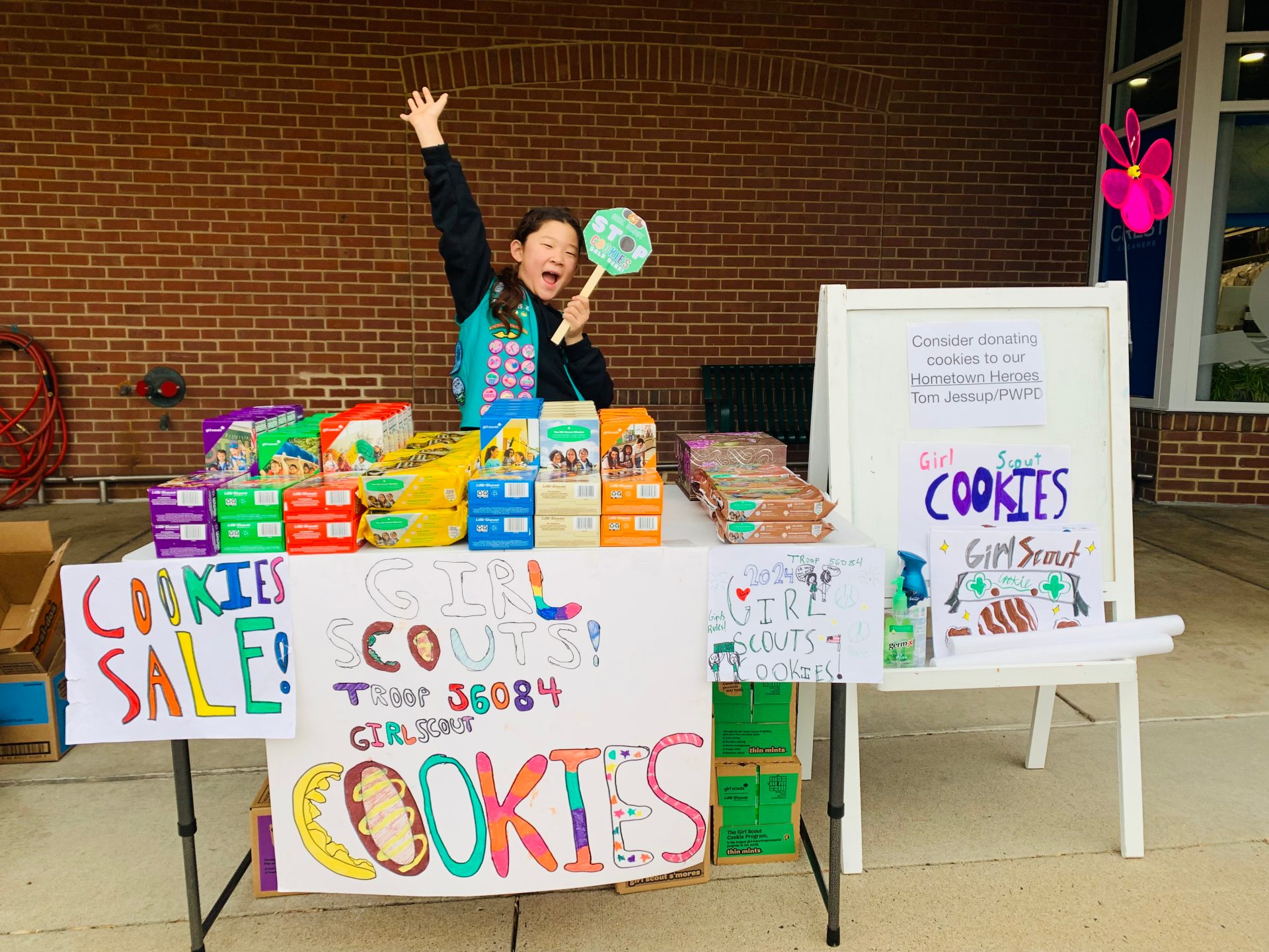 A Girl Scout in front of their cookie booth
