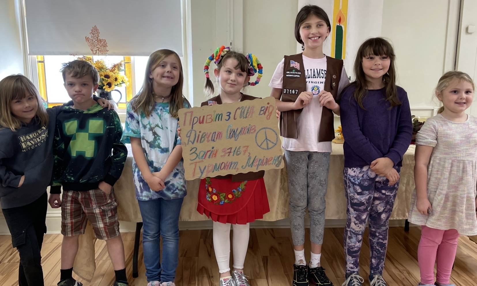 Girl Scout troop 37167 Standing with a greeting to the Girl Guides in Ukraine
