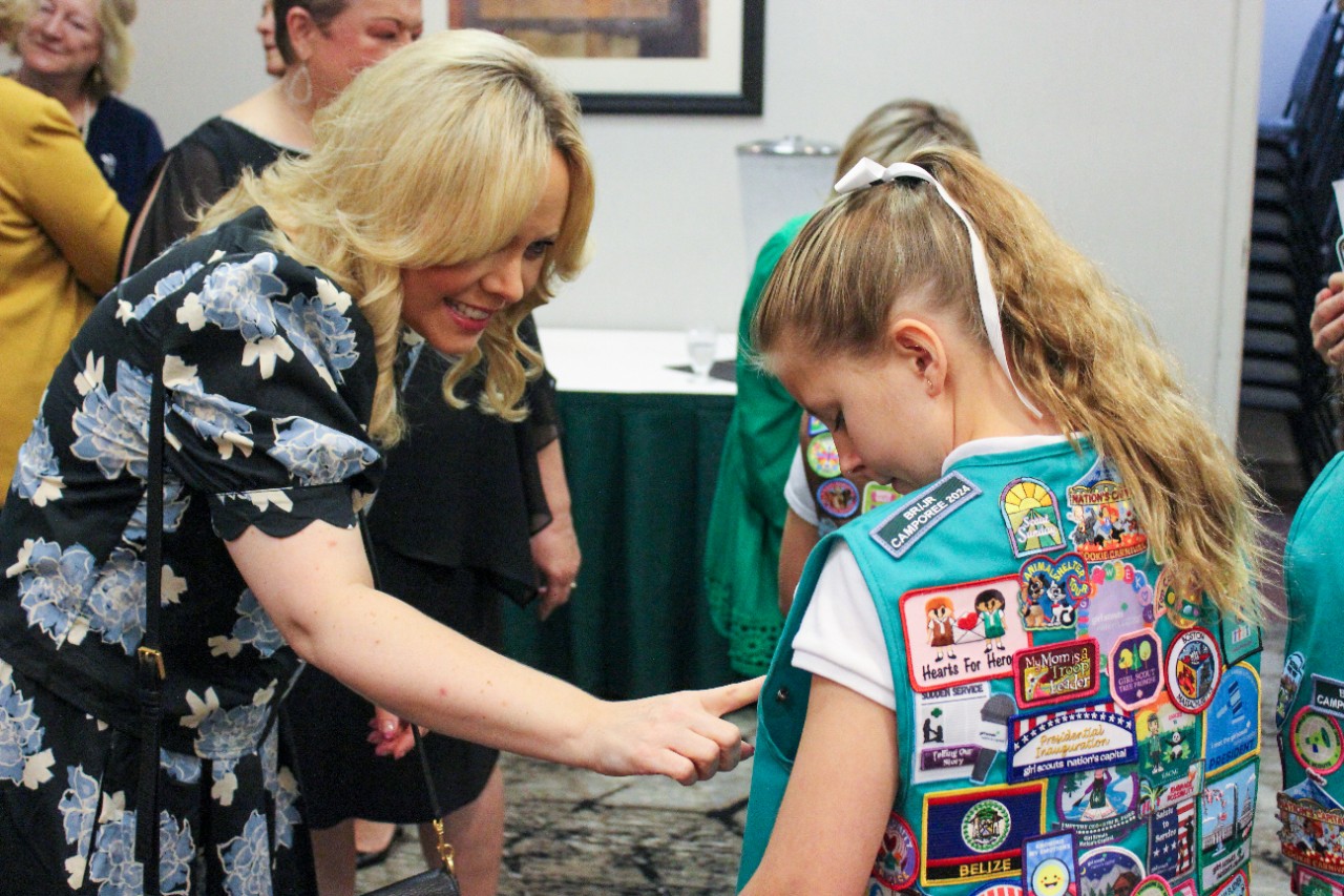 Honorees walking in with Girl Scouts
